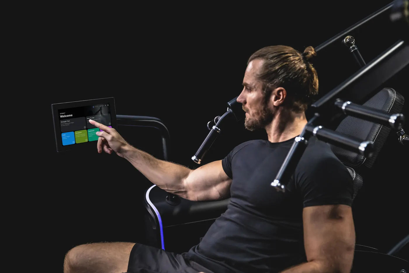 Athlete selecting a program on the iStrength touchscreen