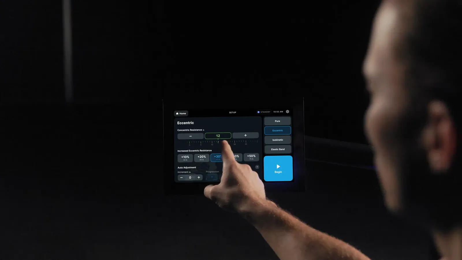 An athlete selects a program on the iStrength touchscreen, then trains with live rep feedback