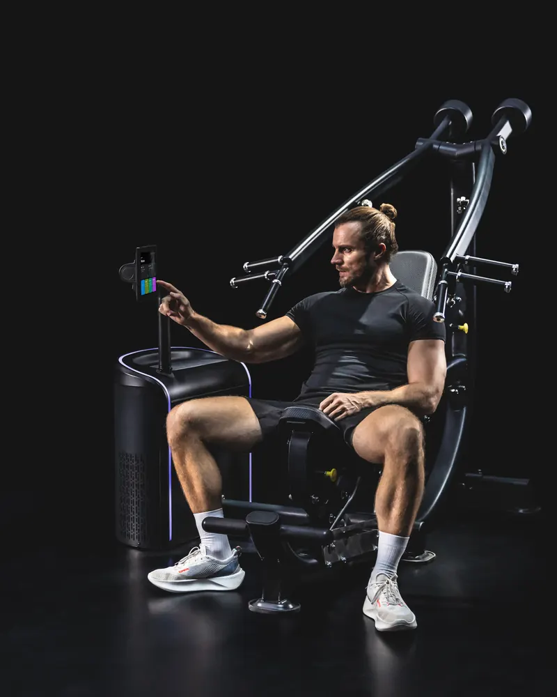 Athlete selecting a program on the Chest/Shoulder Press touchscreen